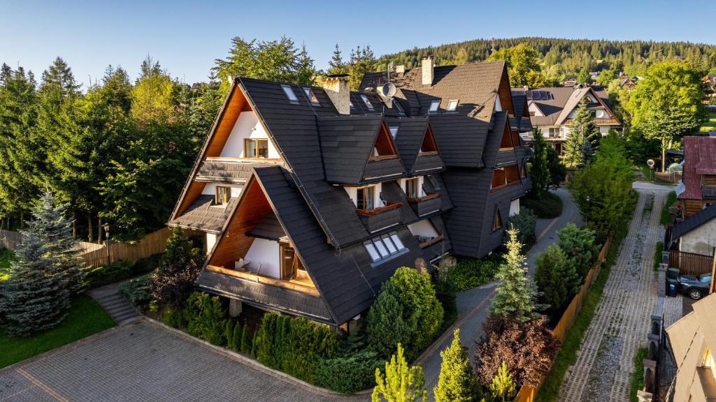 an image of a house with a black roof at Kościelisko - Snowbird Residence Budzówka, Sun & Snow in Kościelisko