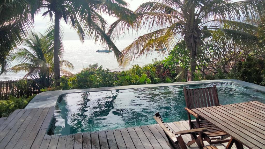 a swimming pool with a table and chairs on a deck at Ebony beach in Vilanculos