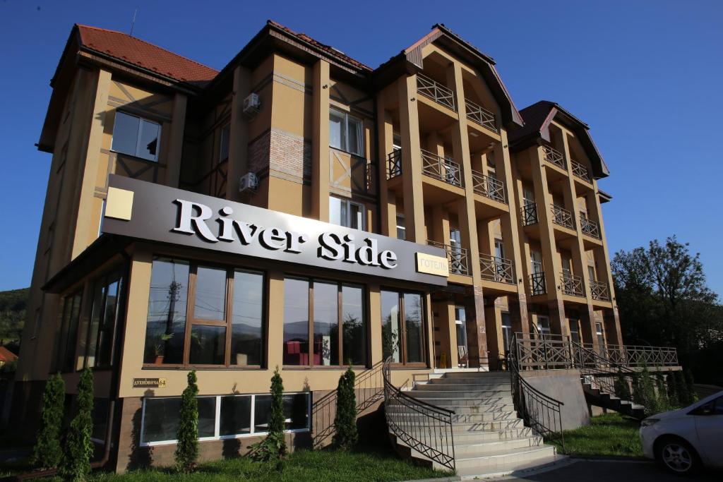 a building with a river side sign on it at RIVER SIDE in Polyana