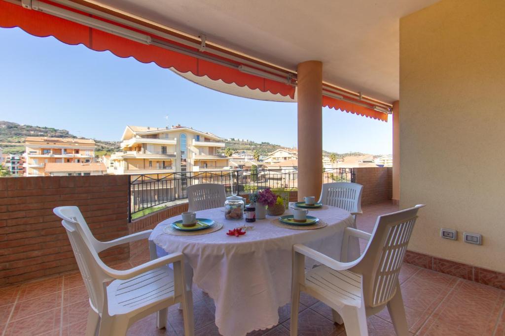 a table and chairs on a balcony with a view at Appartamento Galileo Deluxe - MyHo Casa in Tortoreto Lido