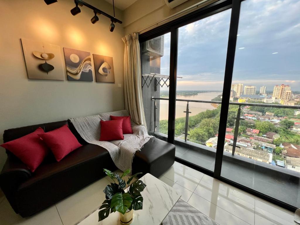 a living room with a couch and a large window at RiverView 8PAX 2BR in KBtown PS4, Netflix A-8-3A in Kota Bharu