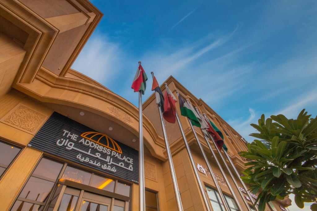 a building with three flags on top of it at The Address Palace Apartments in Dammam