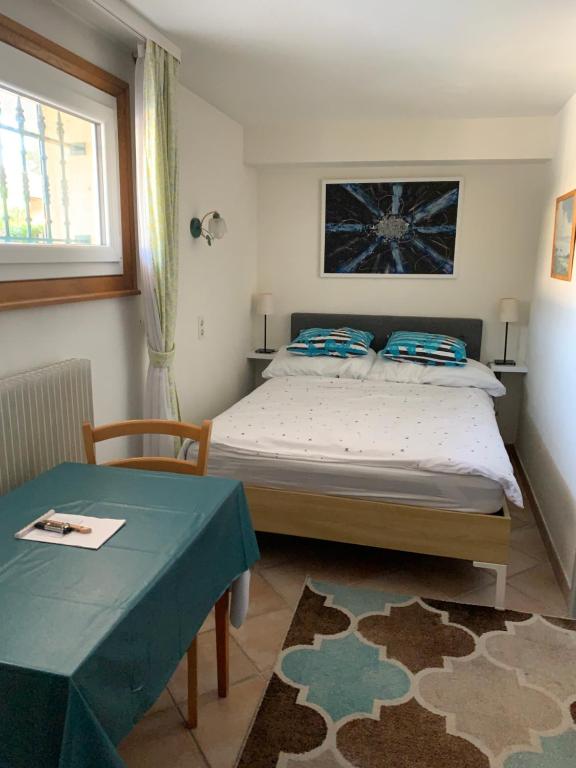 a bedroom with a bed and a table and a window at Chez les Michel in Viry