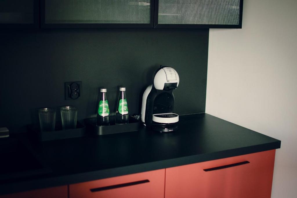 a kitchen counter with a mixer and bottles on it at Apartamenty Centrum in Krotoszyn