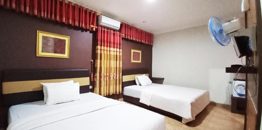 Postel nebo postele na pokoji v ubytování Hotel Syariah GS HERITAGE, Kota Metro