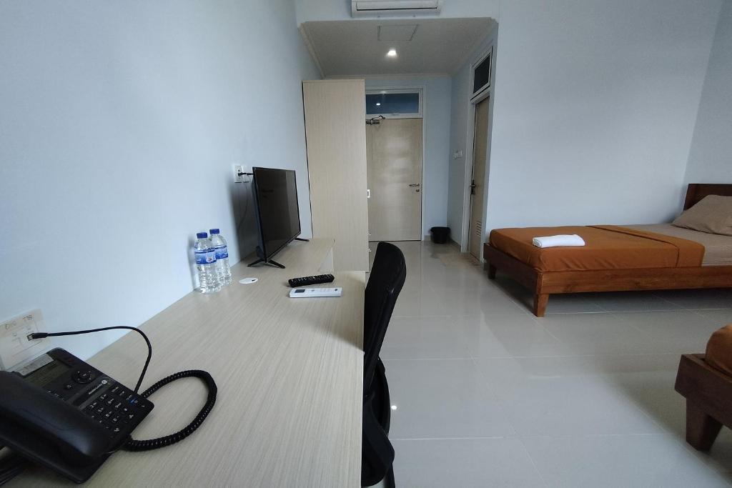 Postel nebo postele na pokoji v ubytování Hotel Sutha Inn Syariah
