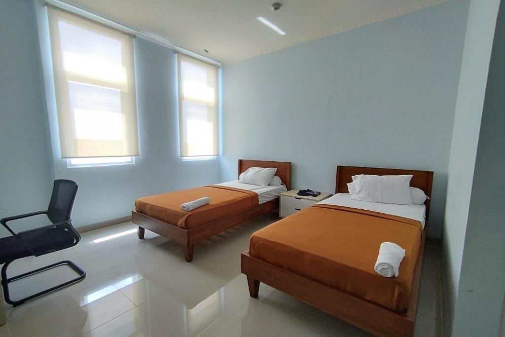 Postel nebo postele na pokoji v ubytování Hotel Sutha Inn Syariah