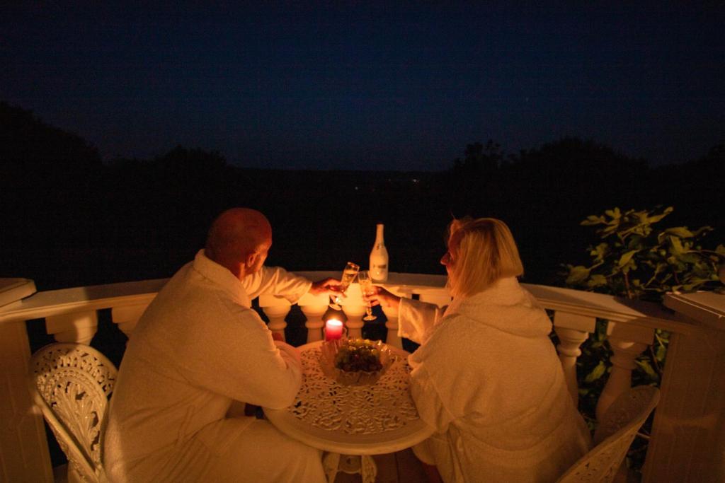 a man and a woman sitting at a table with candles at ARK-LAK 