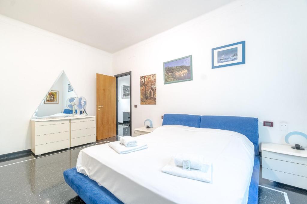 a bedroom with a white bed and a sink at Castelletto Roomy & Functional Flat in Genova