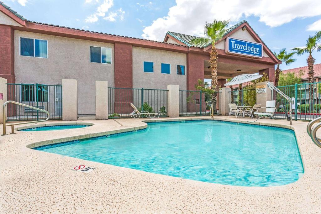 a swimming pool in front of a hotel at Days Inn by Wyndham Phoenix West in Phoenix