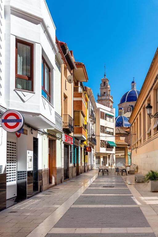 an empty street in a city with buildings at Vilamercat in Sueca
