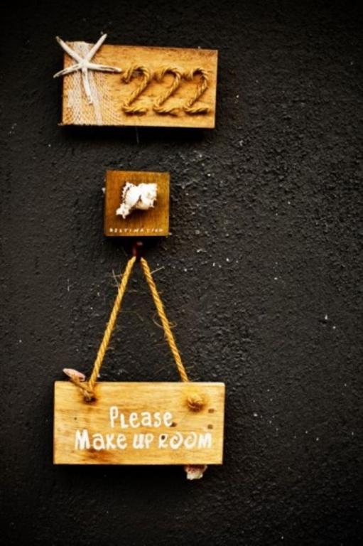 a wooden sign that says please make up room at Deva Beach Resort Samui in Choeng Mon Beach