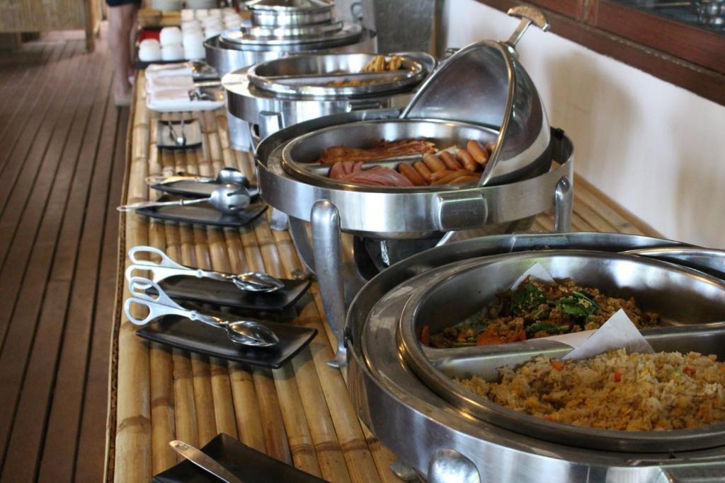 a buffet line with many dishes of food at Deva Beach Resort Samui in Choeng Mon Beach