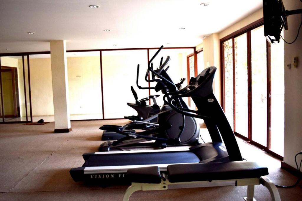 a row of tread machines in a gym at Deva Beach Resort Samui in Choeng Mon Beach