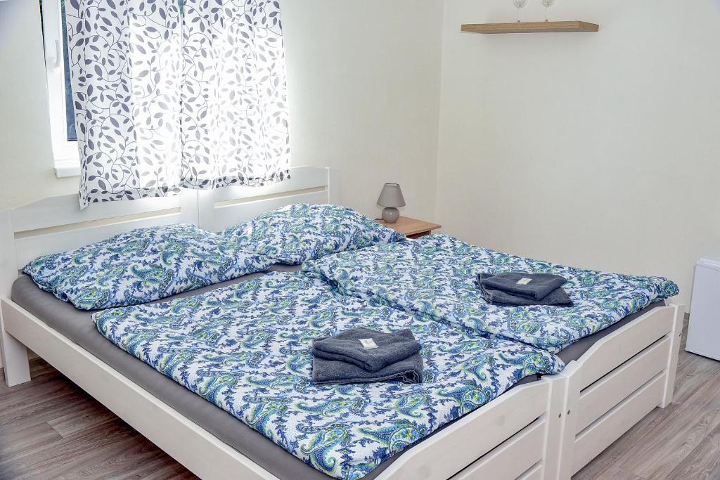 a bed with two pillows on it in a bedroom at Penzion u Vodníka in Třeboň