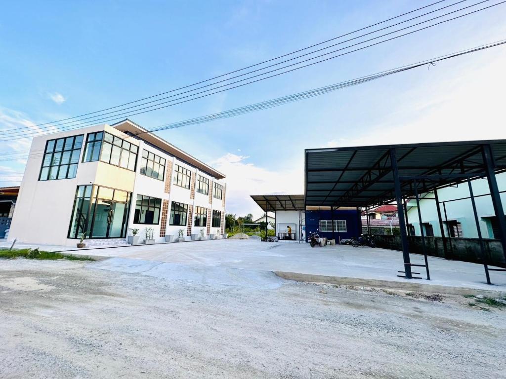 an empty parking lot in front of a building at Art Nara Hotel in Narathiwat