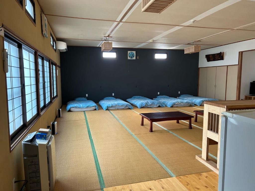 a room with nine beds in a room with a table at SABOJI - Vacation STAY 34265v in Takamori