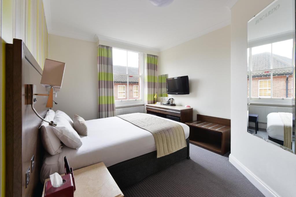 a hotel room with a bed and a television at The Bocardo Hotel in Oxford