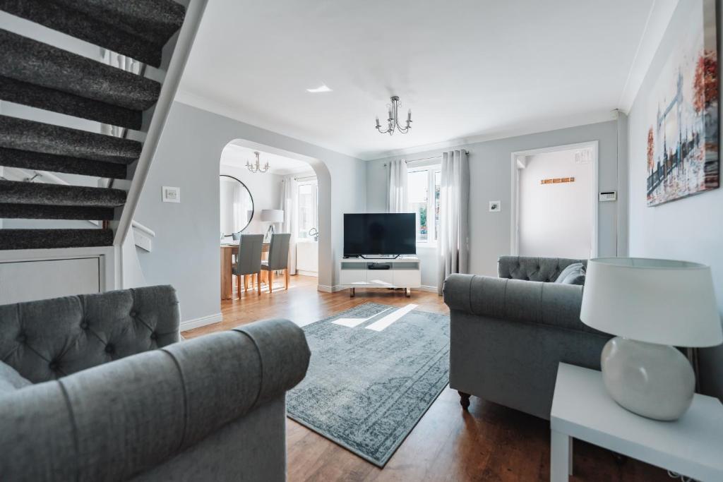 a living room with a couch and a television at Stylish spacious home in Redcar in Kirkleatham