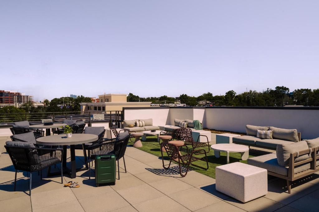 a patio with tables and chairs on a roof at Sonder Belcourt in Nashville