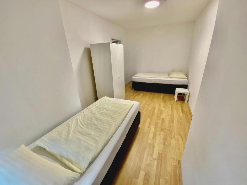 a small room with a bed and a small cabinet at Vienna´s Danube Apartments in Vienna