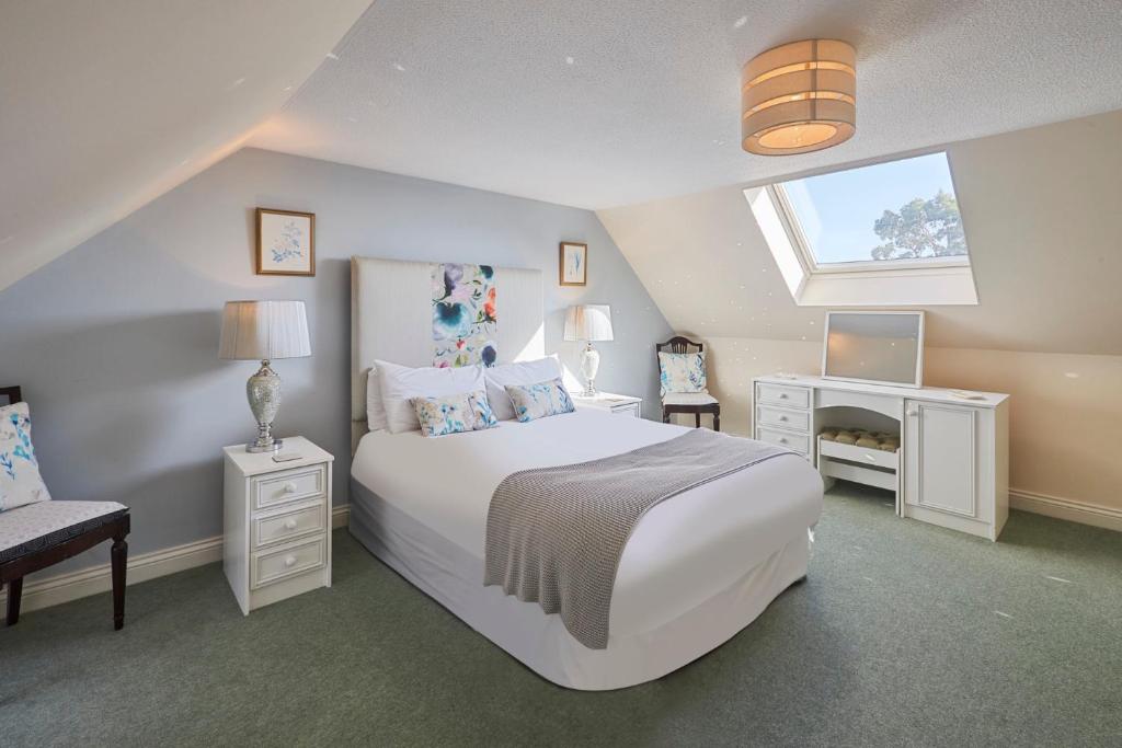 a bedroom with a large white bed and a window at Host & Stay - Grange Cottage in Belford