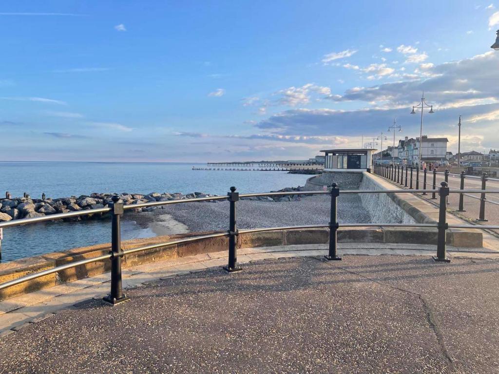 a view of a beach with a pier and the ocean at The Beach House in Lowestoft