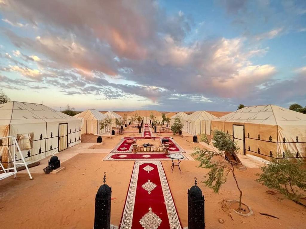 an aerial view of a compound with tents at Family Luxury Glamping in Merzouga