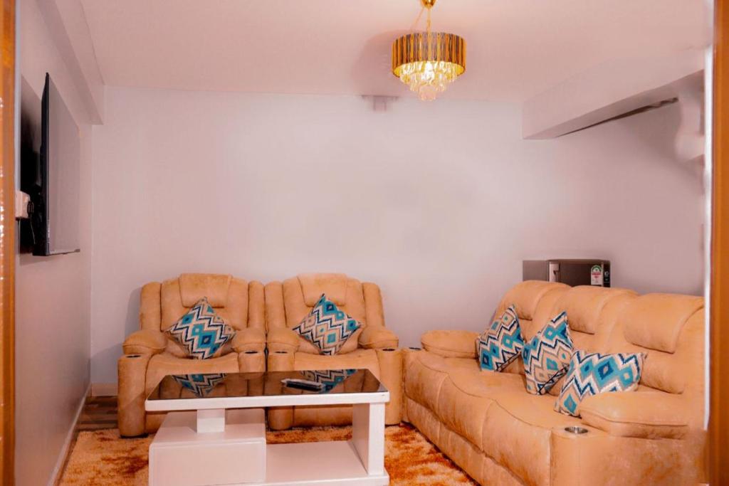 a living room with a couch and two chairs at Sajaairbnb in Narok