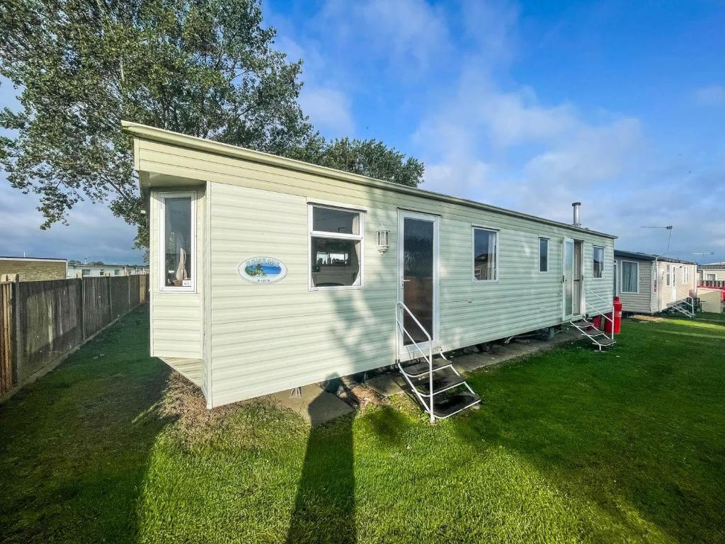 a tiny house sitting in a yard at Caravan By The Sea At California Cliffs Holiday Park In Norfolk Ref 50014b in Great Yarmouth