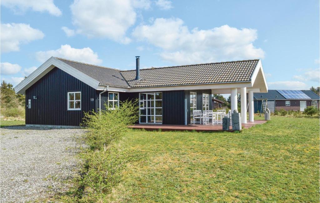 a black and white house with a yard at Stunning Home In Skjern With Kitchen in Lem