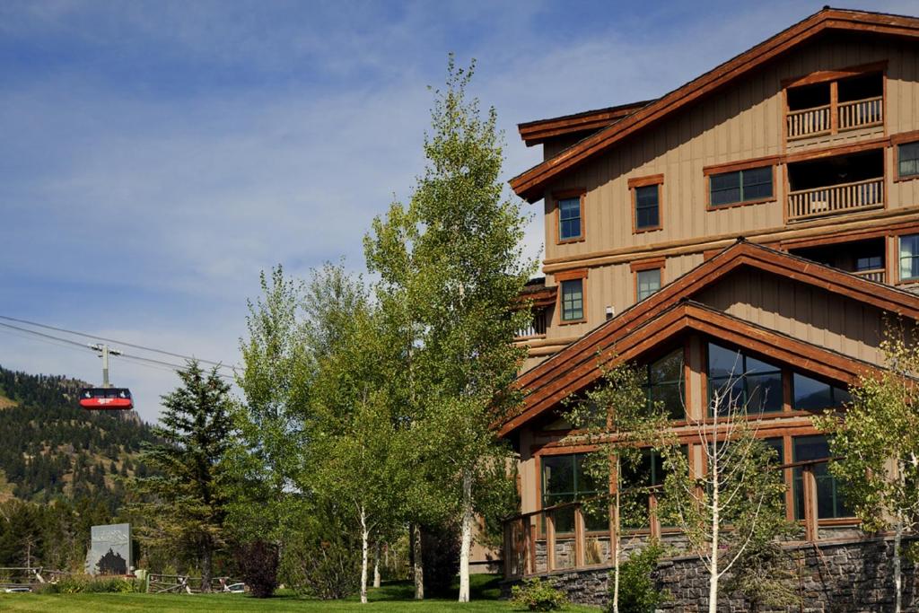 
a large building with a tree in front of it at Teton Mountain Lodge and Spa, a Noble House Resort in Teton Village
