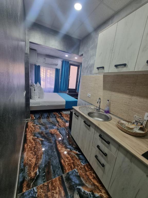 a bathroom with a sink and a counter with a sink at Poet Palace Bucharest in Bucharest
