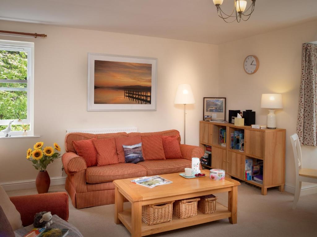 a living room with a couch and a table at Flat 4 in Keswick