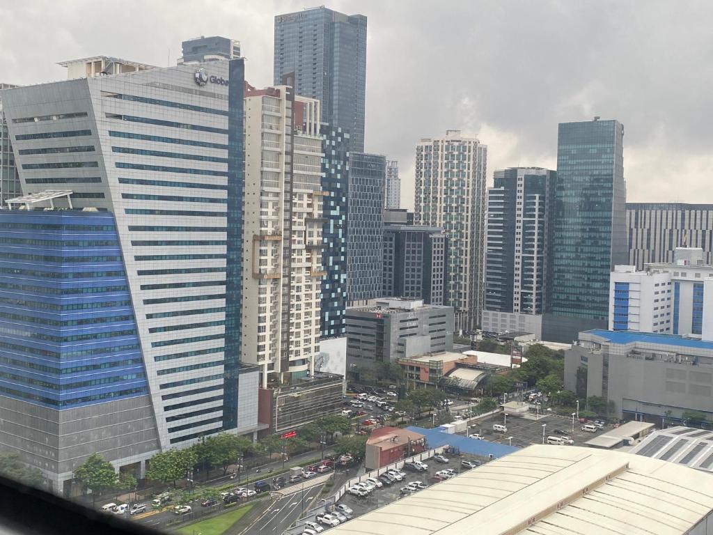 uitzicht op een stad met hoge gebouwen bij Nalag-an Suite w/ city view BGC in Manilla