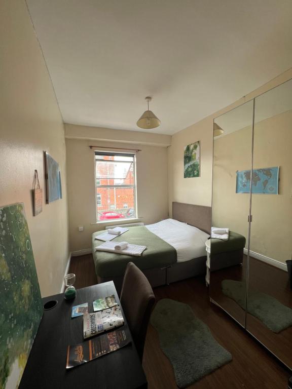 a small room with a bed and a table at Unique Flat in the City Center in Dublin