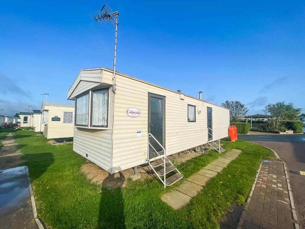 a tiny house on the side of a street at 8 Berth Caravan At California Cliffs By Scratby Beach In Norfolk Ref 50001d in Great Yarmouth
