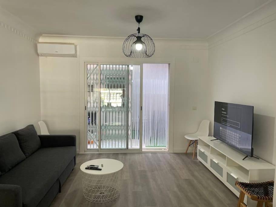 a living room with a couch and a tv at Holiday home Salou in Salou