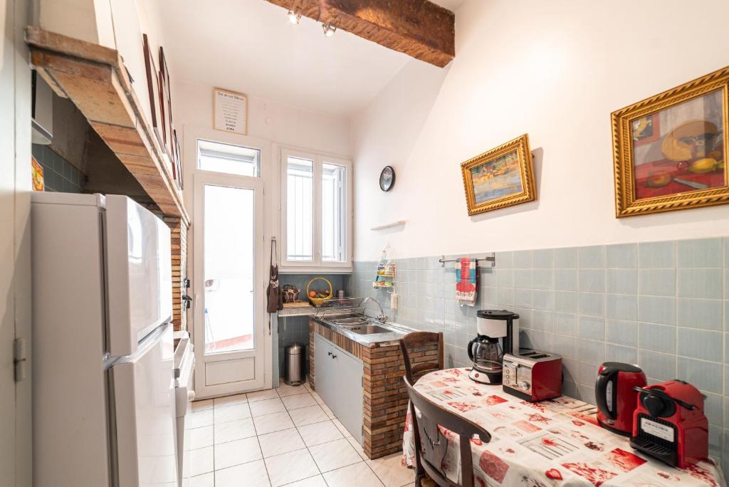 a kitchen with a refrigerator and a counter top at Michelet in Collioure