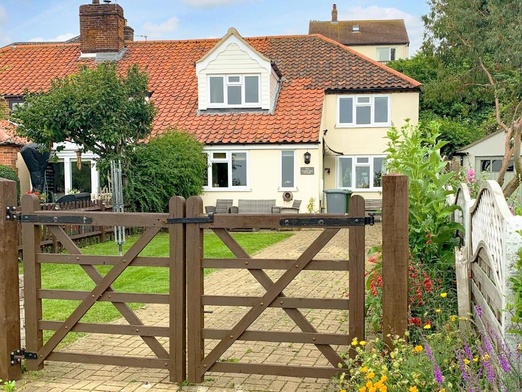 a wooden gate in front of a house at Reedcutters in Reedham