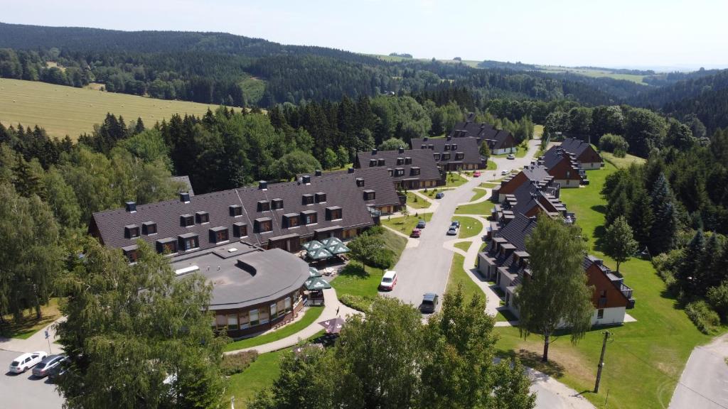 an aerial view of a large building with trees at Wellness Hotel Říčky in Říčky