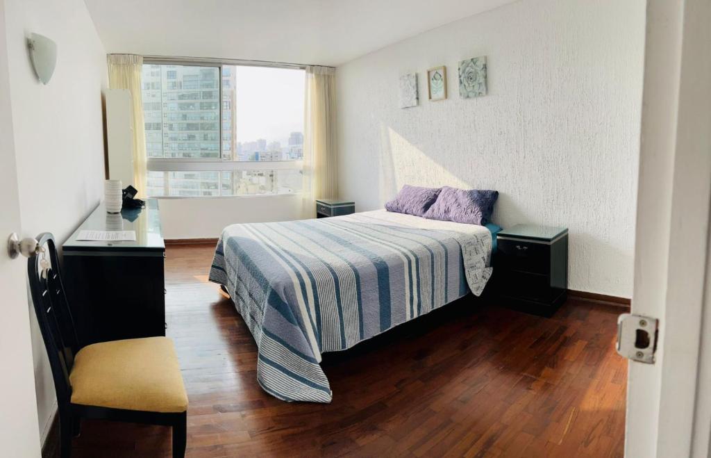 a small bedroom with a bed and a window at The Guest House 1 at the booming center of Miraflores, Lima - Peru in Lima