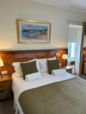 a bedroom with a large bed with two pillows at Inverglen Guest House in Inverness