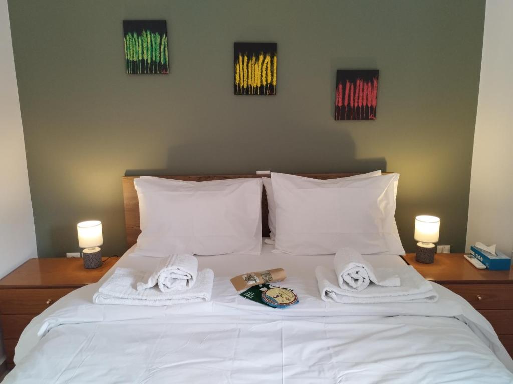 a white bed with towels and books on it at ISLAND TIME in Chios