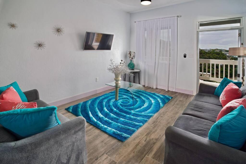 a living room with a blue rug on the floor at Scotland Villa 2 in St Thomas