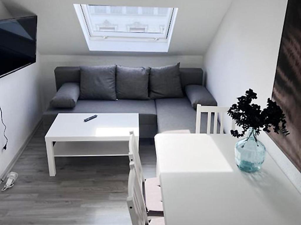 a small living room with a couch and a table at Comfy Apartment in Krefeld in Krefeld
