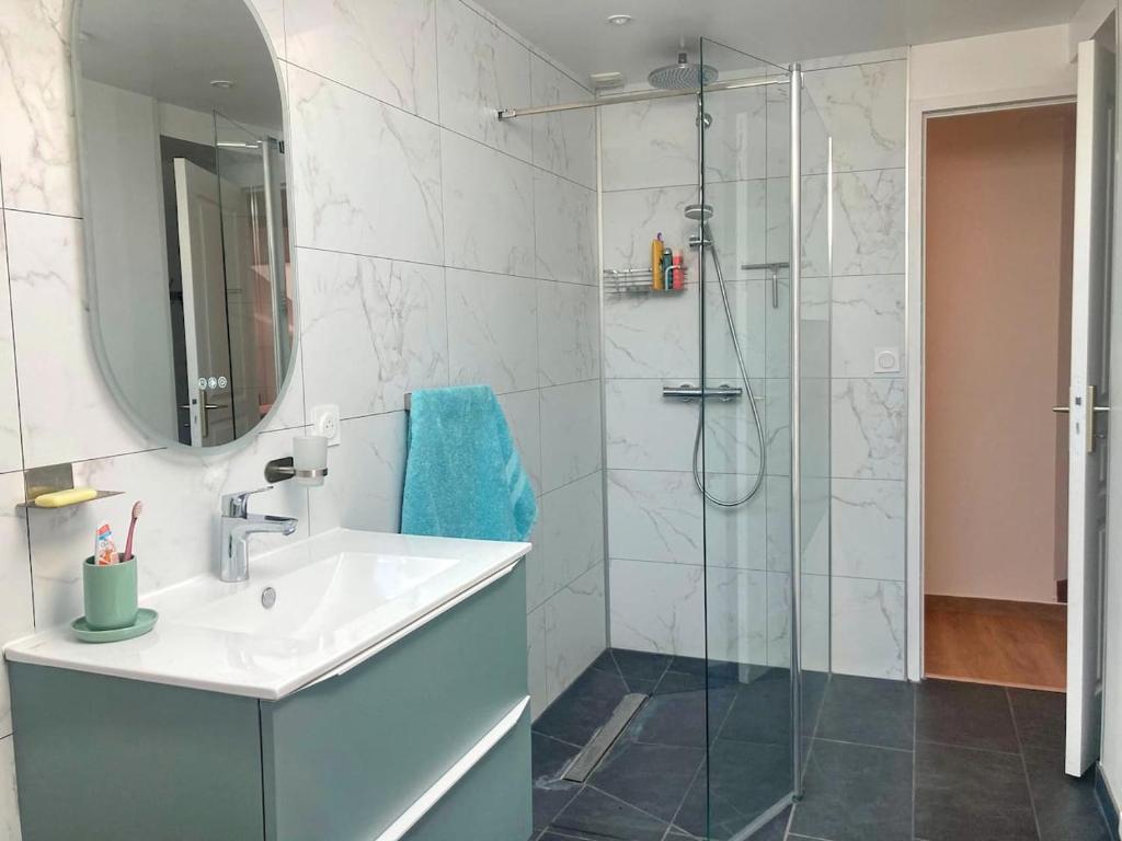 a bathroom with a sink and a shower at Manava Villa vue mer et Mont Saint Michel piscine intérieure in Saint-Jean-le-Thomas