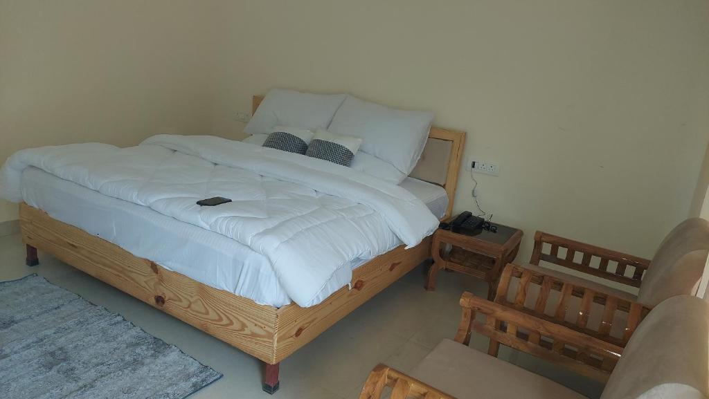 Postel nebo postele na pokoji v ubytování Hotel Anandam phata