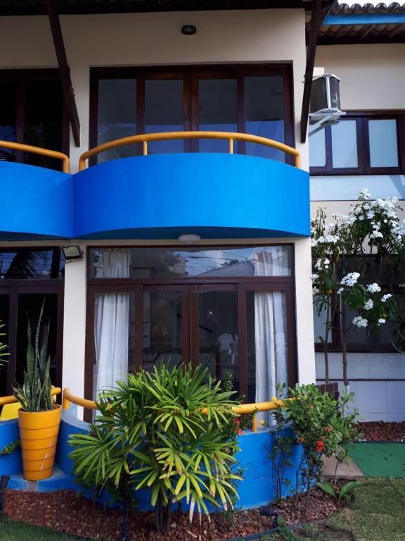 uma casa azul e branca com plantas à sua frente em Casa 02 Quartos em frente às Praias mais belas de Salvador em Salvador