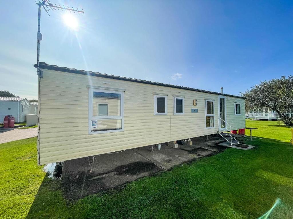 a tiny house on a trailer in a yard at 8 Berth Caravan At Broadland Sands Holiday Park In Suffolk Ref 20140bs in Hopton on Sea